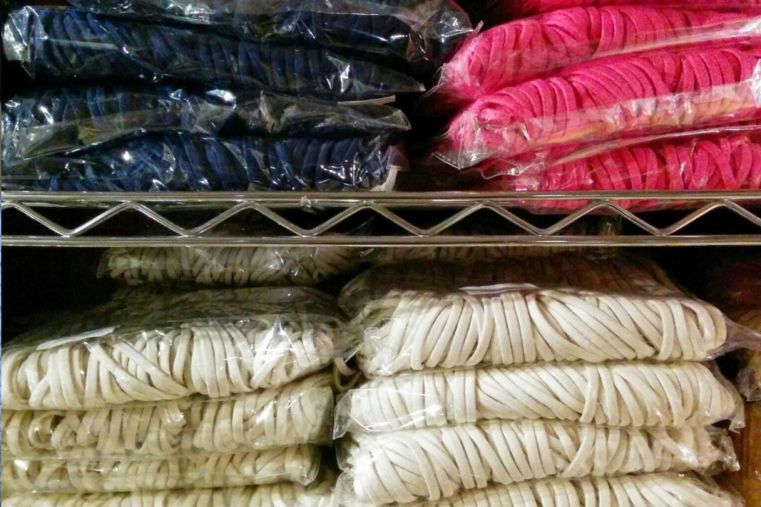 stacks of bulk packages elastic hair ties on shelves
