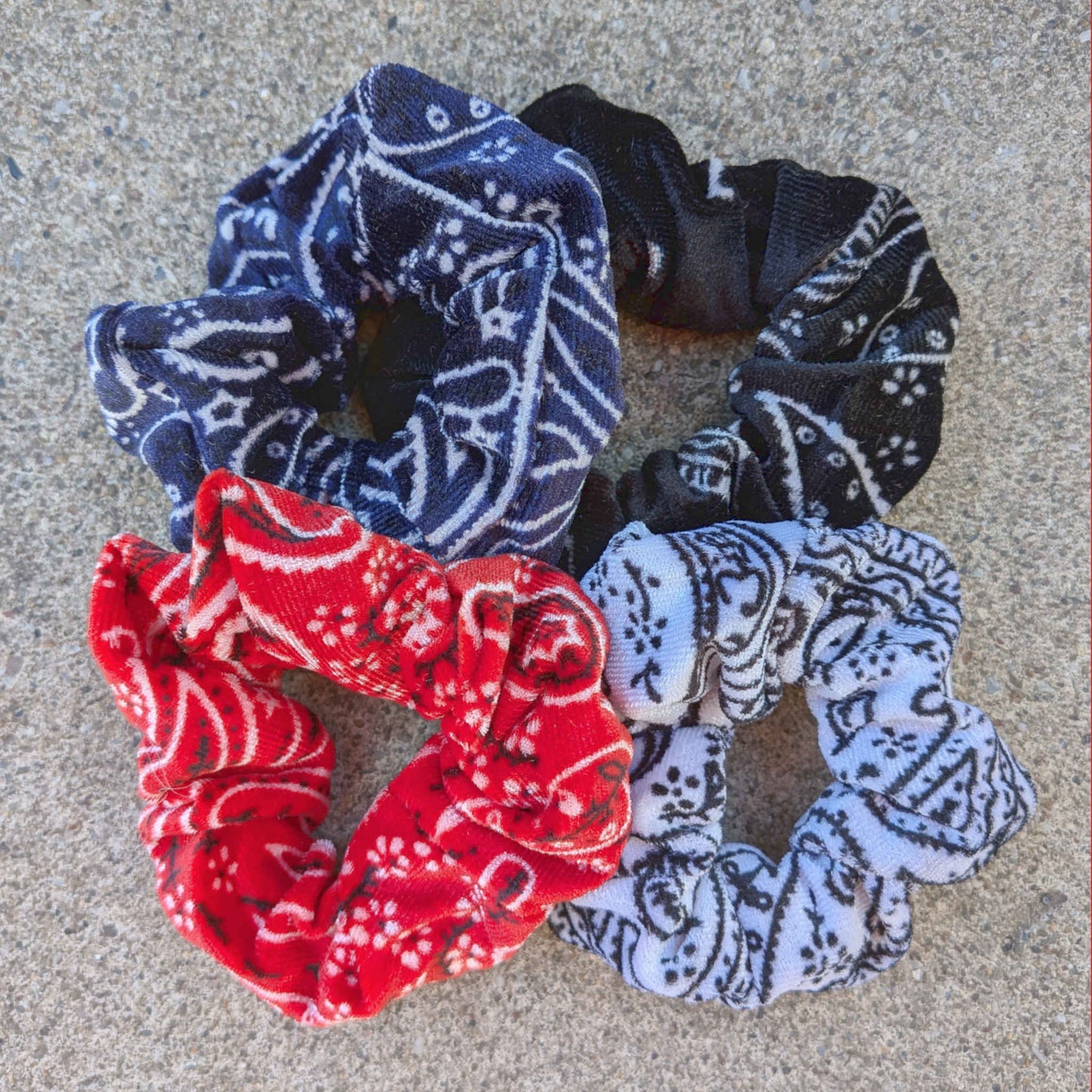 set of bandana print velvet scrunchies in red, navy, black and white